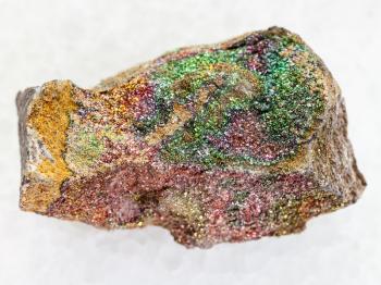 macro shooting of natural mineral rock specimen - raw rainbow pyrite stone on white marble background from Ulyanovsk region, Russia