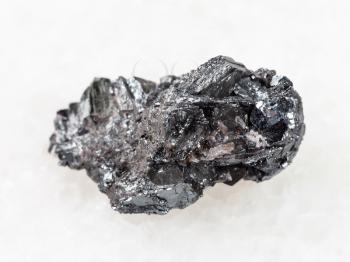 macro shooting of natural mineral rock specimen - raw hematite ore on white marble background from Kazakhstan