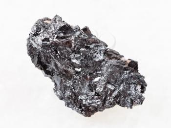 macro shooting of natural mineral rock specimen - piece of hematite ore on white marble background from Kazakhstan