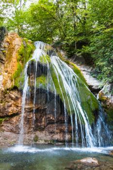 travel to Crimea - water flows in Djur-djur waterfall on Ulu-Uzen river in Haphal Gorge of Habhal Hydrological Reserve natural park in Crimean Mountains in autumn.