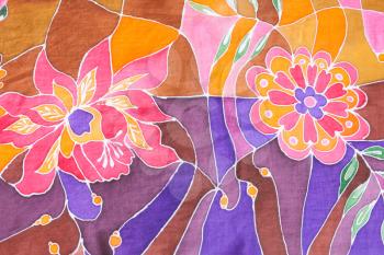 textile background - hand painted floral ornament on silk batik scarf