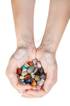 top view of handful with various gemstones isolated on white background