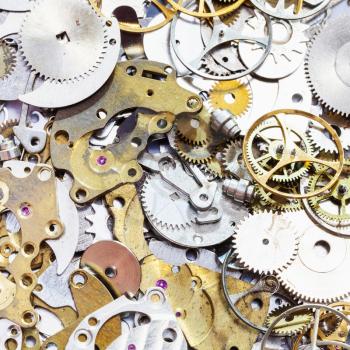 watchmaker workshop - pile of old watch spare parts close up
