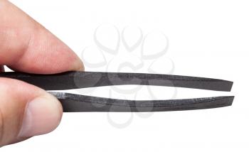 male fingers hold black plastic flat tweezers isolated on white background