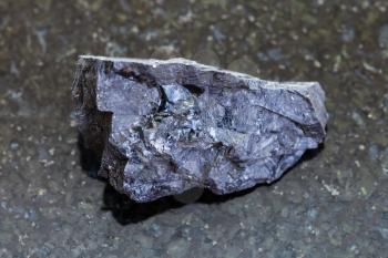 macro shooting of natural mineral rock specimen - raw Anthracite coal on dark granite background