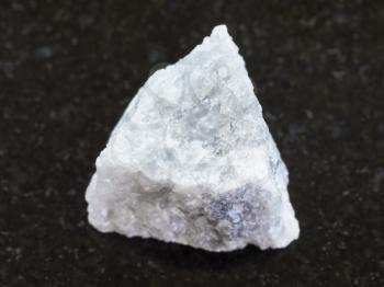 macro shooting of natural mineral rock specimen - rough gray Marble stone on dark granite background