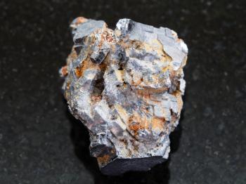 macro shooting of natural mineral rock specimen - rough Galenite stone on dark granite background
