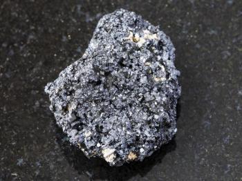 macro shooting of natural mineral rock specimen - Perovskite stone on dark granite background