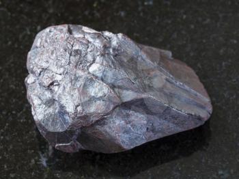 macro shooting of natural mineral rock specimen - hematite stone on dark granite background from Kazakhstan