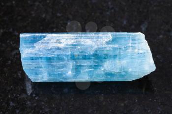 macro shooting of natural mineral rock specimen - crystal of aquamarine (blue beryl) gemstone on dark granite background from Sherlova Gora (Sherlovaya Gora) mine, Transbaikalia (Zabaykalye), Russia