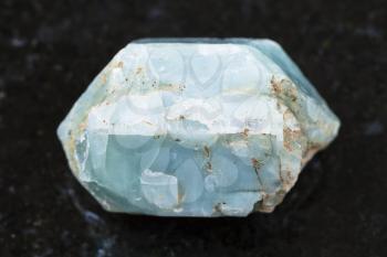 macro shooting of natural mineral rock specimen - raw crystal of blue apatite gemstone on dark granite background from Slyudyanka district, Irkutsk region, Russia