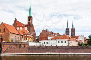 travel to Poland - view of building of Collegiate Church of the Holy Cross and St Bartholomew in Ostrow Tumski district in Wroclaw city from Oder River