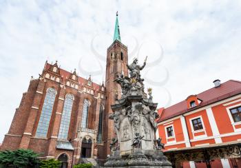 travel to Poland - John of Nepomuk ( St John Nepomucen) statue near Collegiate church of the Holy cross and St Bartholomew in Ostrow Tumski of Wroclaw city in Wroclaw city in september