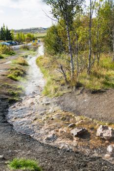 travel to Iceland - warm water flow in Haukadalur hot spring valley in autumn