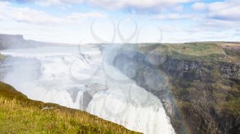 travel to Iceland - view of rainbow in water spray over Gullfoss waterfall in september