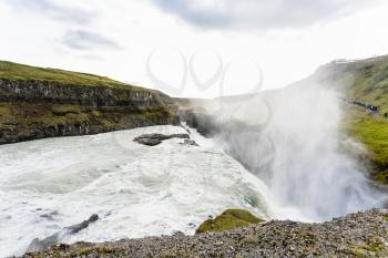 travel to Iceland - stream of Gullfoss waterfall and water spray over canyon of Olfusa river in september