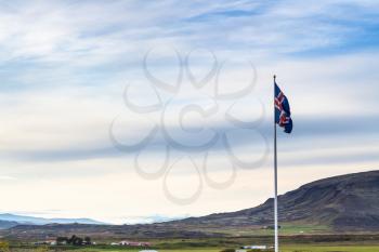 travel to Iceland - icelandic flag and landscape near Kerid Lake in september evening