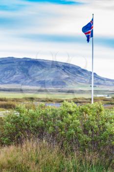 travel to Iceland - icelandic flag near Kerid Lake in september evening
