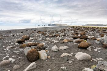 travel to Iceland - surface of Reynisfjara Beach and view of Dyrholaey peninsula in Iceland, near Vik I Myrdal village on Atlantic South Coast in Katla Geopark in autumn