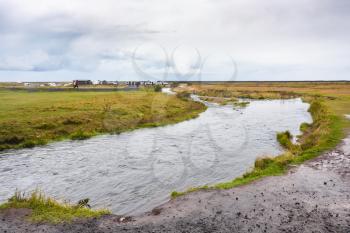 travel to Iceland - wet riverbanks of Seljalands River near Seljalandsfoss waterfall in Katla Geopark on Icelandic Atlantic South Coast in september