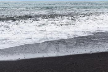 travel to Iceland - ocean surf on Reynisfjara black beach in Iceland, near Vik I Myrdal village on Atlantic South Coast in Katla Geopark in september