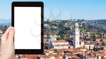 travel concept - tourist photographs above view of Verona city with Duomo Cathedral from tower Torre dei Lamberti in spring on tablet with cut out screen for advertising logo