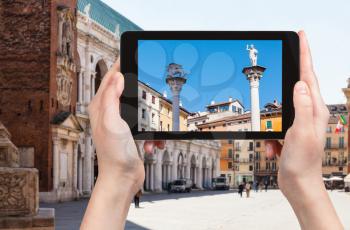 travel concept - tourist photographs monuments on Piazza dei Signori in Vicenza city in Italy on tablet