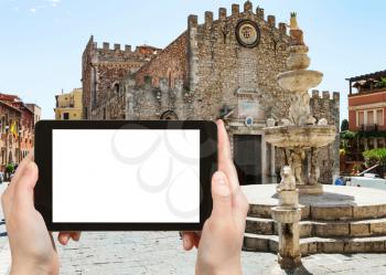 travel concept - tourist photographs Quattro Fontane di Taormina on Piazza dell Duomo near Cathedral San Nicolo di Bari in Taormina city in Sicily Italy in summer season on tablet with cut out screen