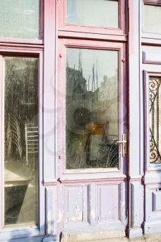 travel to France - closed shabby door with glass panel in Boulogne-sur-Mer city in summer morning