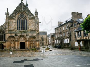 travel to France - Basilica of St Saviour on square Place Saint-Sauveur of Dinan town in rain