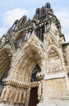 Travel to France - outdoor portal of Reims Cathedral (Notre-Dame de Reims) in summer evening
