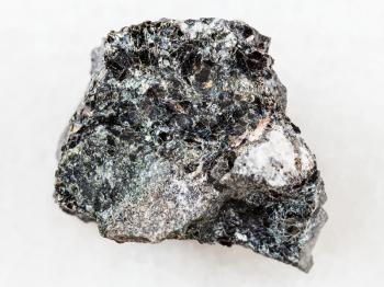 macro shooting of natural mineral rock specimen - Magnetite ore on white marble background from Kovdor, Karelia, Russia