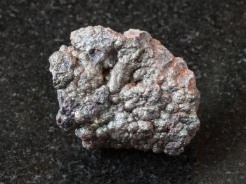 macro shooting of natural rock specimen - Goethite stone (brown iron) on black granite background from Tharsis, Spain