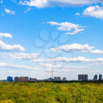 view of residential district under blue sky near green forest of Timiryazevsky park in Moscow city in sunny summer day