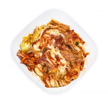 korean cuisine - above view of kimchi appetizer (spice nappa cabbage) in white bowl isolated on white background