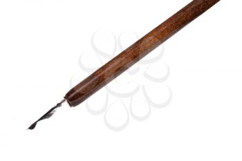 side view of black ink drop in nib of brown dip pen close up isolated on white background