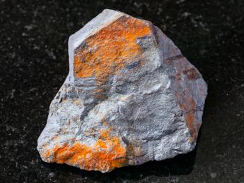 macro shooting of natural rock specimen - raw Hematite ore on black granite background from Brazil