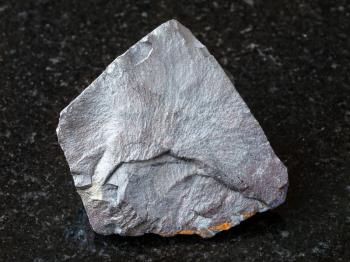 macro shooting of natural rock specimen - Hematite ore on black granite background from Brazil