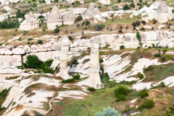 Travel to Turkey - above view of fairy chimney rocks on mountain slope in Goreme National Park in Cappadocia in spring