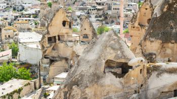 Travel to Turkey - ancient rock-cut houses in Goreme town in Cappadocia in spring