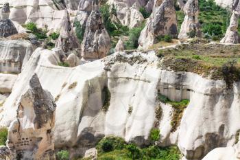 Travel to Turkey - ancient rocks houses on mountaion slope in Goreme National Park in Cappadocia in spring