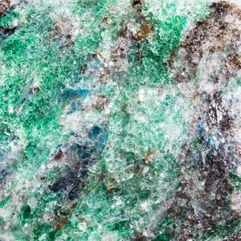 macro shooting of natural texture of green Fuchsite rock (chrome mica) witn blue Kyanite crystals from Kola Peninsula