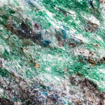 macro shooting of natural texture of green Fuchsite mineral (chrome mica) witn blue Kyanite crystals from Kola Peninsula