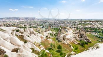 Travel to Turkey - panoramic view of mountain slope and Goreme town in Cappadocia in spring