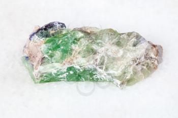 macro shooting of natural mineral - raw green Beryl, Chrysoberyl, Alexandrite crystals on white marble from Ural Mountains