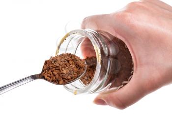female hand keeps glass jar and spoon with soluble coffee isolated on white background