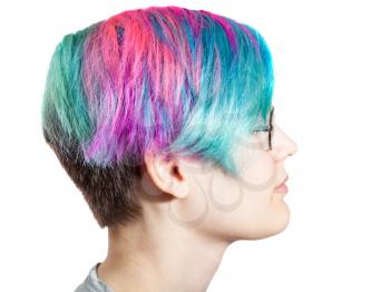head of young woman with glasses and multi colored dyed hairs on white background