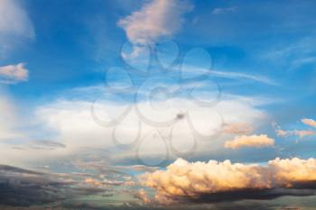 blue sunset sky with white and yellow cumuli clouds over Moscow at summer sunset