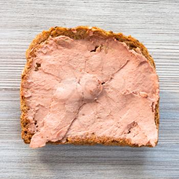 top view of bread sandwich with pate on gray wooden table