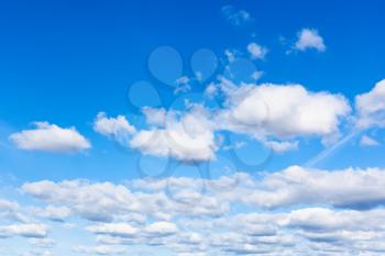 fluffy clouds in blue sky in sunny september day